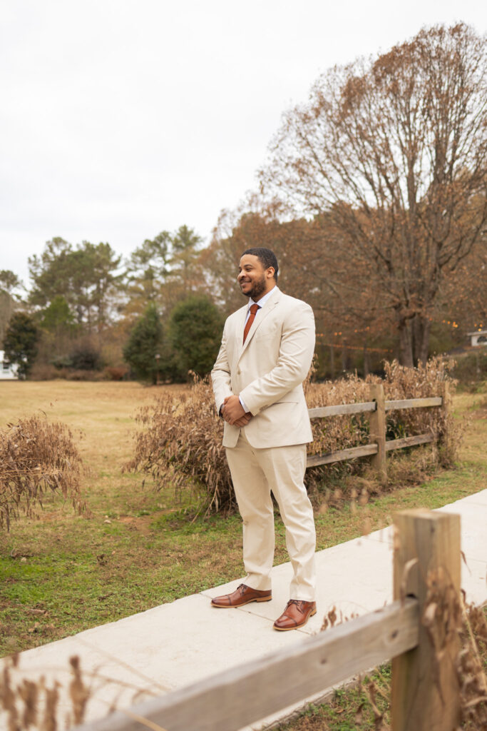 Groom waiting for bride before the first look, standing outside the 2425 warehouse in Monroe, GA