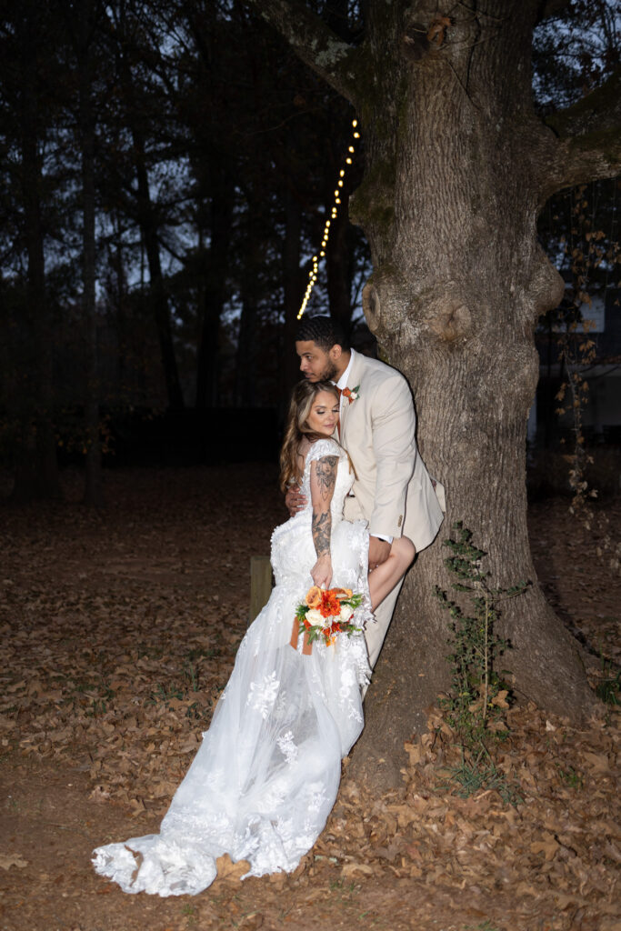 Vintage flash couple's photos, bride and groom kissing against tree