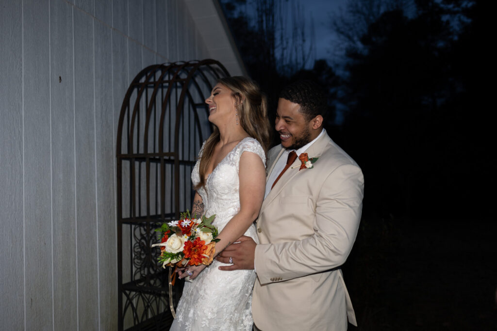 Bride and groom laughing during couple's portraits, 2425 warehouse Monroe GA